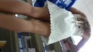 Hot blonde shopper shows a nice ass under her white skirt i