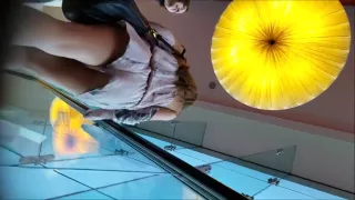 Upskirt shots on an escalator show two sexy chicks' nice as