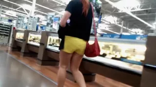 Sexy shopper with a luscious ass in bright yellow shorts is
