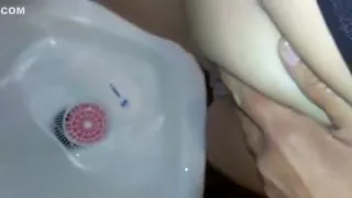 Pissing in a toilet that is public