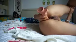 Ass toying in the bed with big dildo