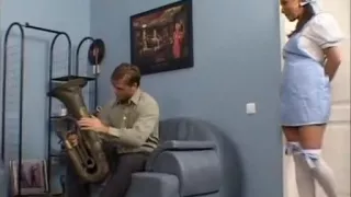 sexy brunette babe seducing her boyfriend  with saxophone