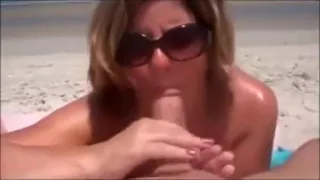Wife with my cock in her mouth at the beach