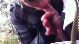 Streetslut sucks off a guy in the forest, until he cums in the condom.