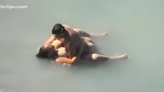 Voyeur busts a bbw with huge tits fucking in the sea