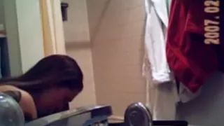 Voyeur captures a hot brunette naked in the bathroom