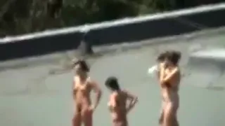 Voyeur tapes 4 girls tanning with their boobs naked on a roof with his cellphone