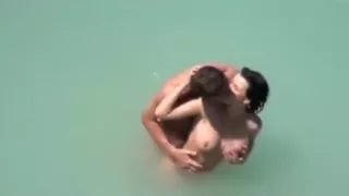 Voyeur tapes a couple at a nude beach making-out