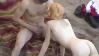 voyeur tapes a girl riding and sucking her boyfriend  at a nude beach