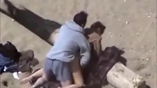 Voyeur tapes a horny couple fucking at the beach