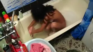 Voyeur tapes a hot girl playing with herself in the bathtub