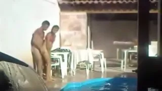 Voyeur tapes a latin couple having sex on the side of the pool
