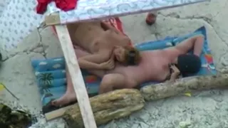 Voyeur tapes a nudist couple having oral sex at the beach