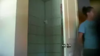 Voyeur tapes a ponytailed brunette girl taking a shower