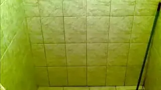 Voyeur tapes a ponytailed brunette taking a shower