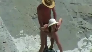 Voyeur tapes a skinny girl having a doggystyle quickie on a nude beach