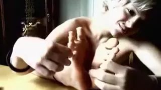 Flexible blonde sniffs her feet in a weird webcam solo video