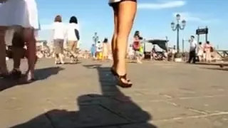 Hot babe in the city center walking in high heel shoes