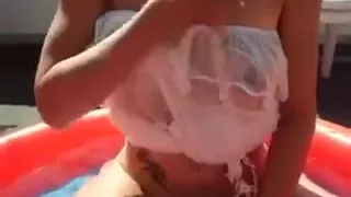 Slender white wife with saggy boobs is in the inflatable pool