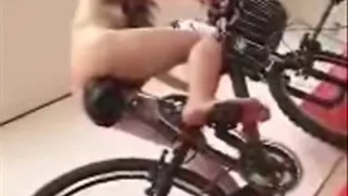 Asian girl tests out the dildo bicycle