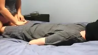 blindfolded and tied up guy gets a handjob from his chubby girlfriend  on the bed