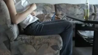 Blonde fucks herself with a flask on the sofa