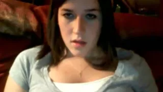 Brunette girl rubs her shaved pussy standup on cam