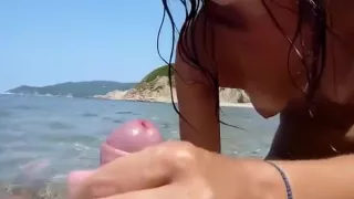 brunette rides her boyfriend  in the sea and jerks him off to a cumshot