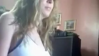 Chubby brunette girl shows off her big boobs, big booty and rubs her shaved pink pussy closeup on a chair.