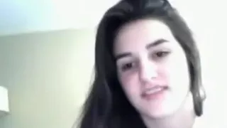 Cute girl plays with her small tits, sticks a hairbrush in her pussy and rubs herself to orgasm on her bed.