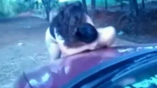 Fat slut fucks a guy in the bar of a car and on the hood, while his friend tapes it.