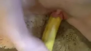 Girl masturbates her shaved pussy closeup with a banana