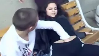 girl slut lets 2 friends play with her tits and pussy on a bench in public