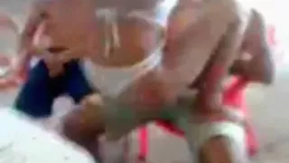 Latina dances naked on a table in a bar and sticks a flask in her pussy