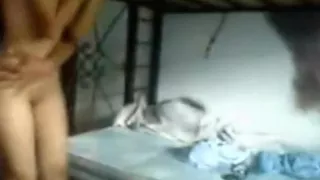 Latina girl fucks 2 guys missionary and doggystyle, while a porn flick is playing on tv.