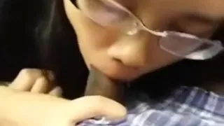 Nerdy asian girl with glasses sucks her black bf's cock in the car on a parking lot