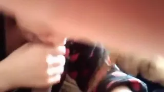 ponytailed asian girl gives her white boyfriend  a pov blowjob on the bed, until he cums in her mouth.