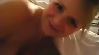 Ponytailed brunette sucks her bf's cock pov on the bed and rubs it on her tits