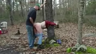 Redneck slut, tied to a tree in the forest, gets doggystyle fucked.