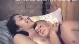 russian guy has missionary sex with condom with his girlfriend  on the bed, while a friend tapes the action.