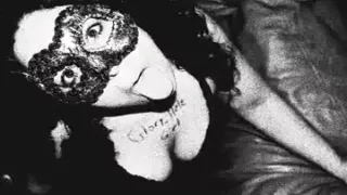 Masked babe sucks cock in a glory hole.