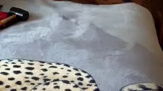 Hitting balls with rubber mallet in wetsuit