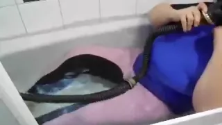 in pink jodhpur and gasmask in the bathtub