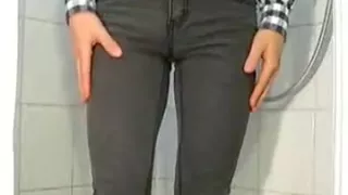 peeing four times in gray skinny jeans