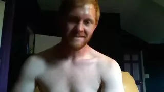 Pretty man is relaxing in a small room and filming himself on computer webcam