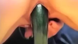 A massive zucchini going in the shaved pink filthy cleft of mine