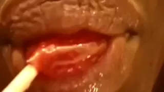 Check out wet glossed soft lips sucking a lollipop