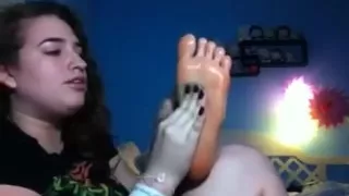 Scarlett massaging her feet with oil