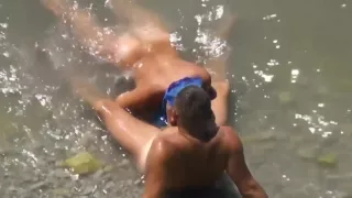Girl sucks dick her boyfriend in the surf at a public beach