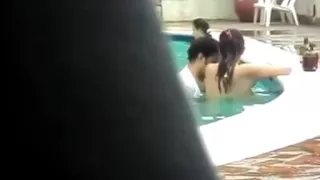 Pair copulates in public pool with people around 'em